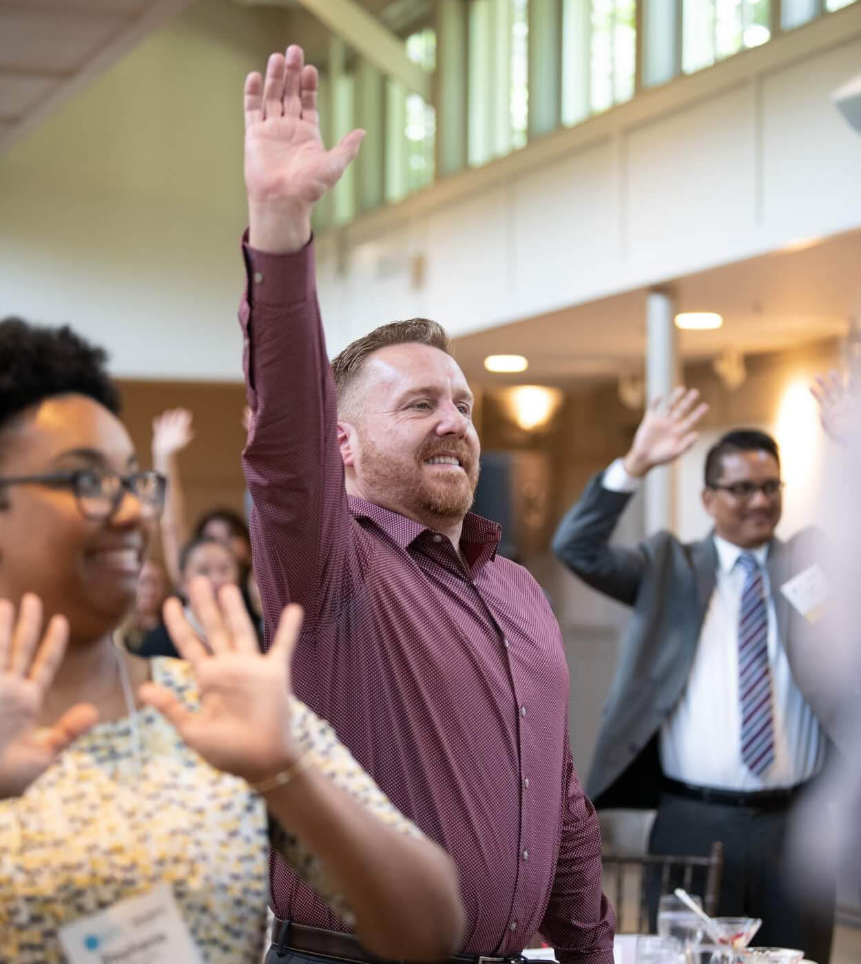 male attendee raising his hand