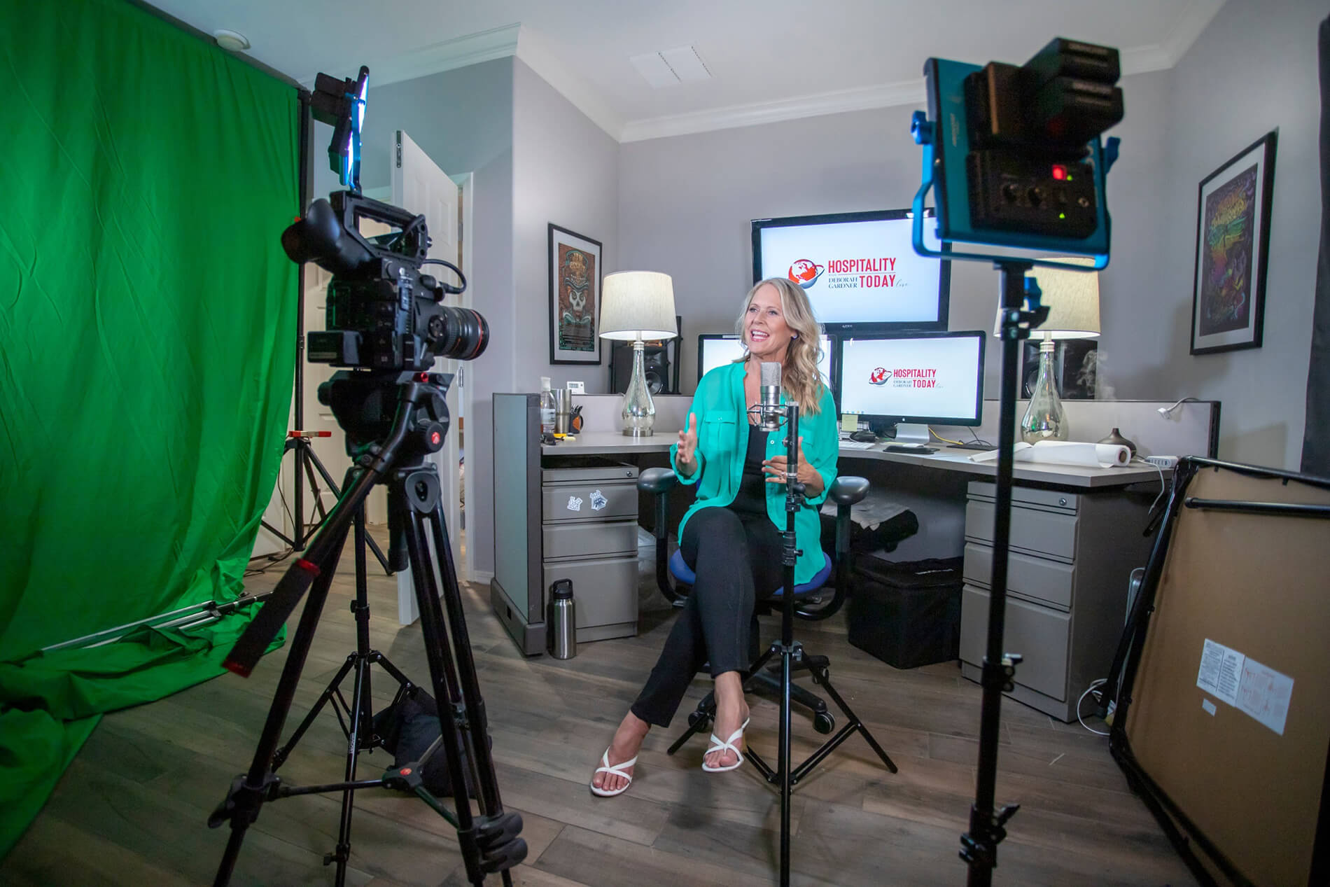 deborah sitting in front of a camera in a recording studio